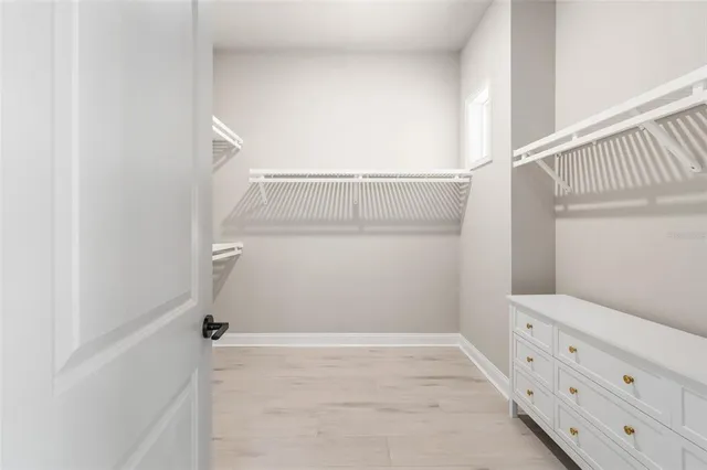 a view of a livingroom with a ceiling fan and window