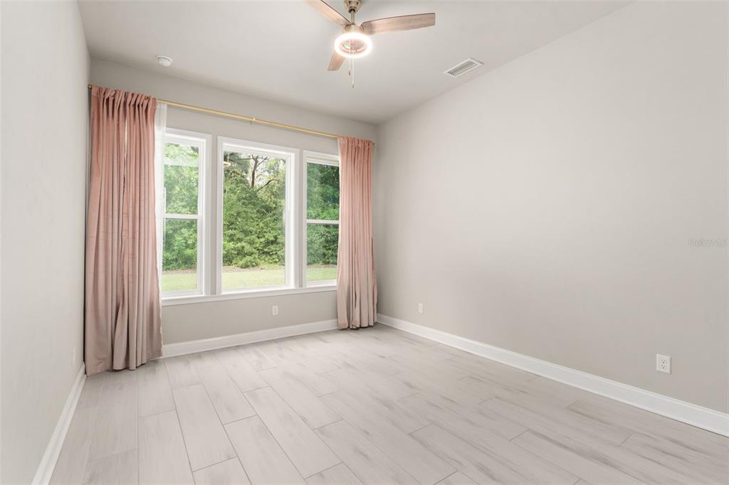 3474 Southwest 109 Drive Gainesville, FL 32608 - Photo 32 of 60 a view of a livingroom with a ceiling fan and window