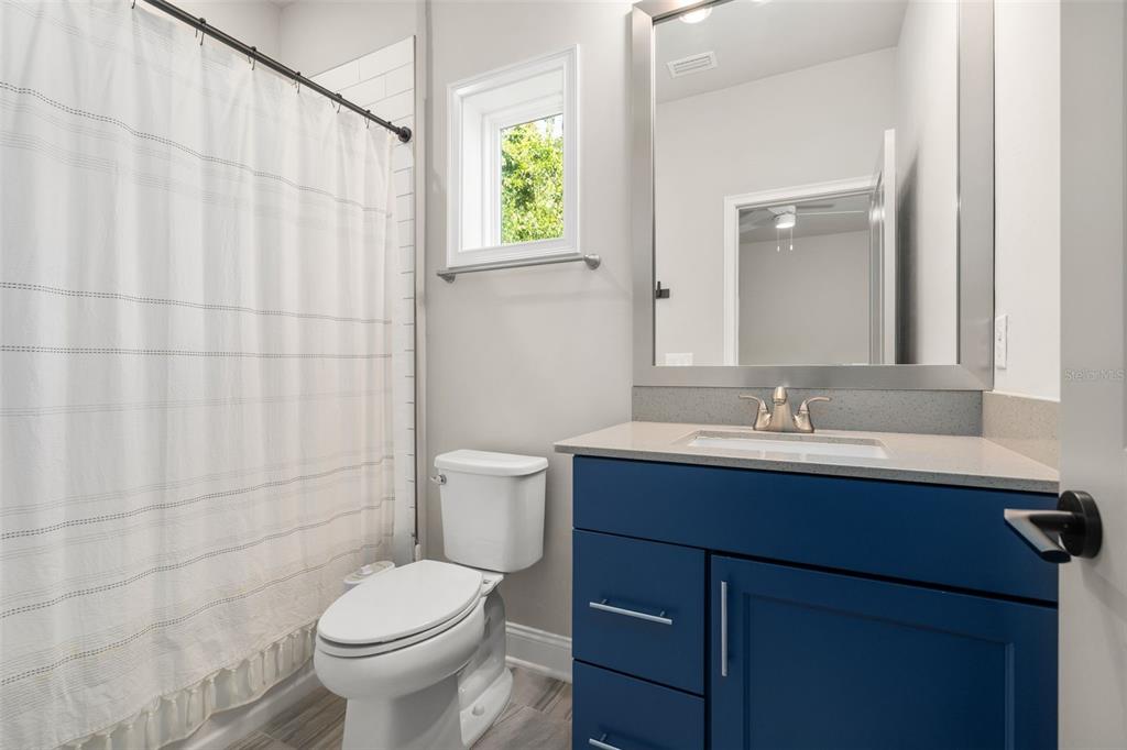 3474 Southwest 109 Drive Gainesville, FL 32608 - Photo 37 of 60 a bathroom with a sink vanity mirror and toilet