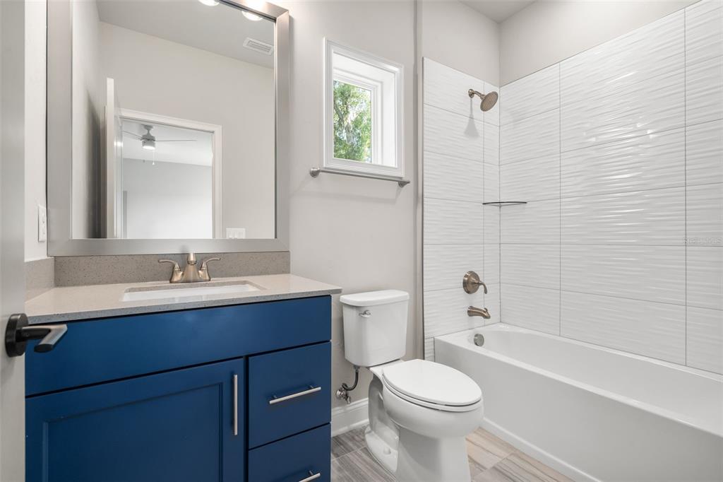 3474 Southwest 109 Drive Gainesville, FL 32608 - Photo 38 of 60 a bathroom with a sink toilet a mirror and shower