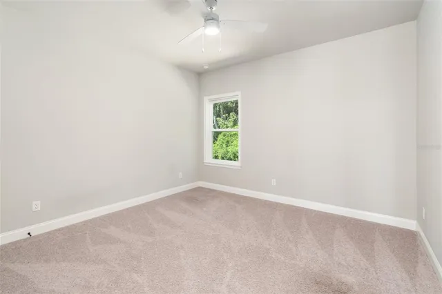 a front view of a house with yard and green space