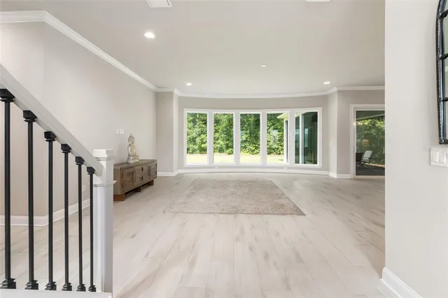 a view of hallway with stairs and wooden floor