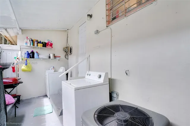 a view of a chair and table in backyard of the house