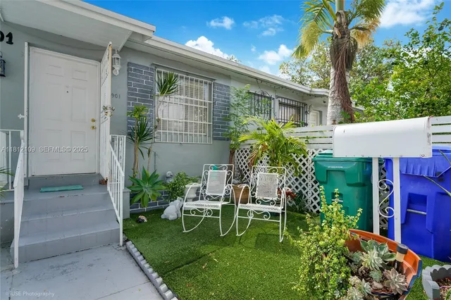 a view of backyard with seating space and trees