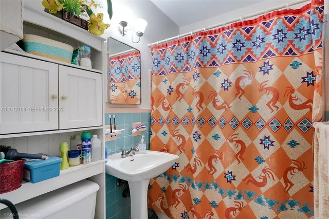 a kitchen with a sink dishwasher and white cabinets
