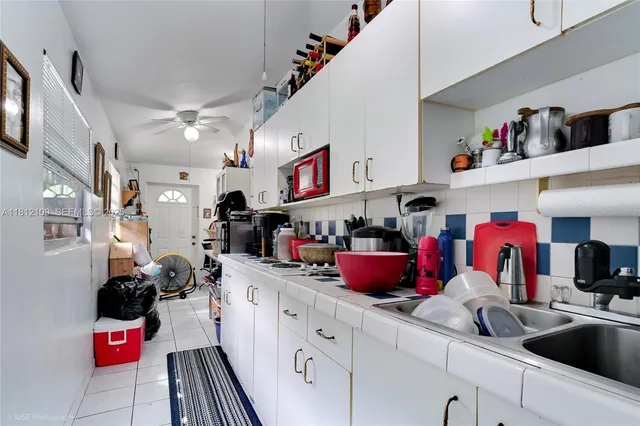 a view of a garage with a table and chairs under an umbrella