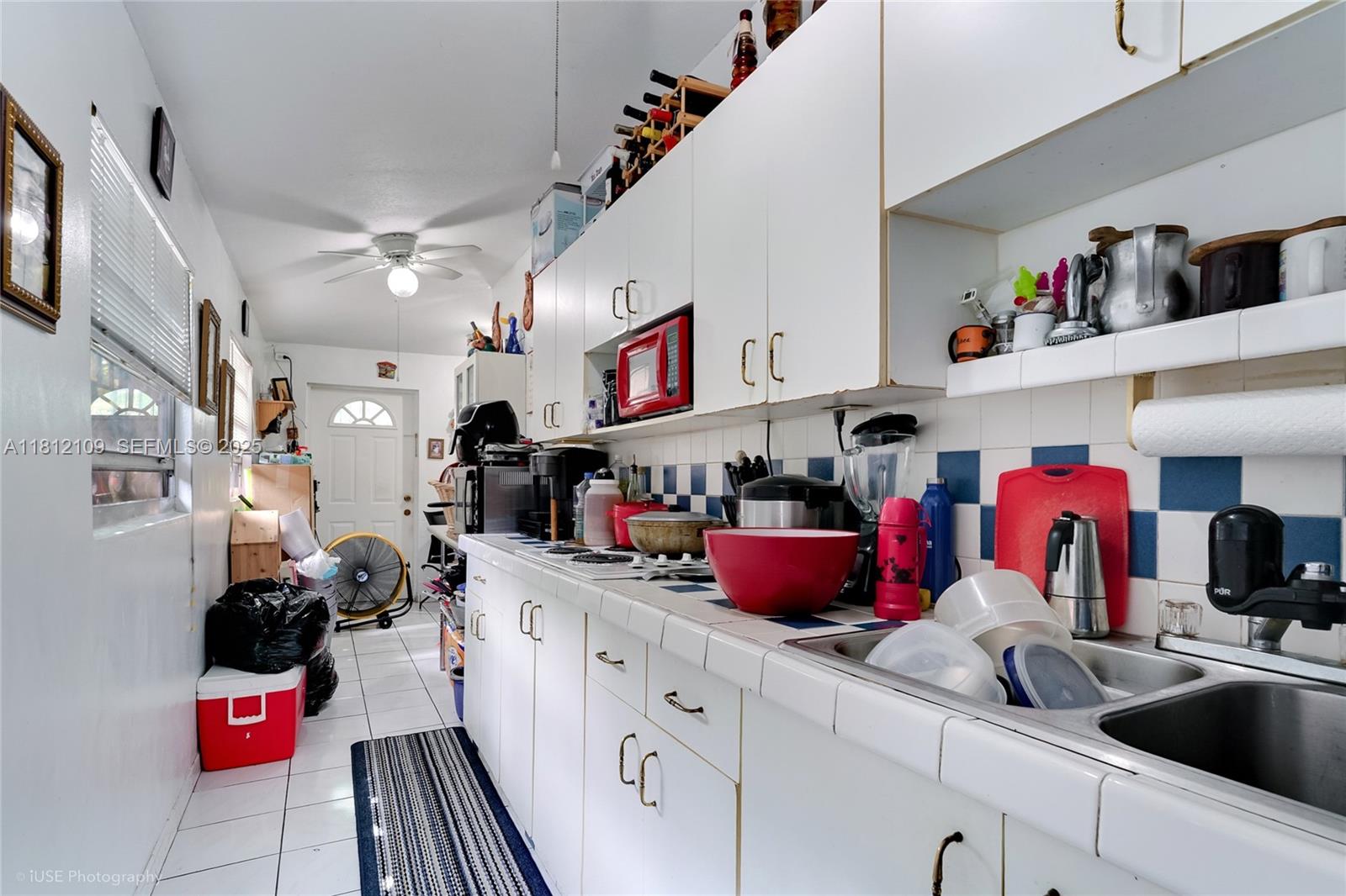 901 Southwest 34th Avenue Miami, FL 33135 - Photo 17 of 18 a kitchen with a sink dishwasher and white cabinets