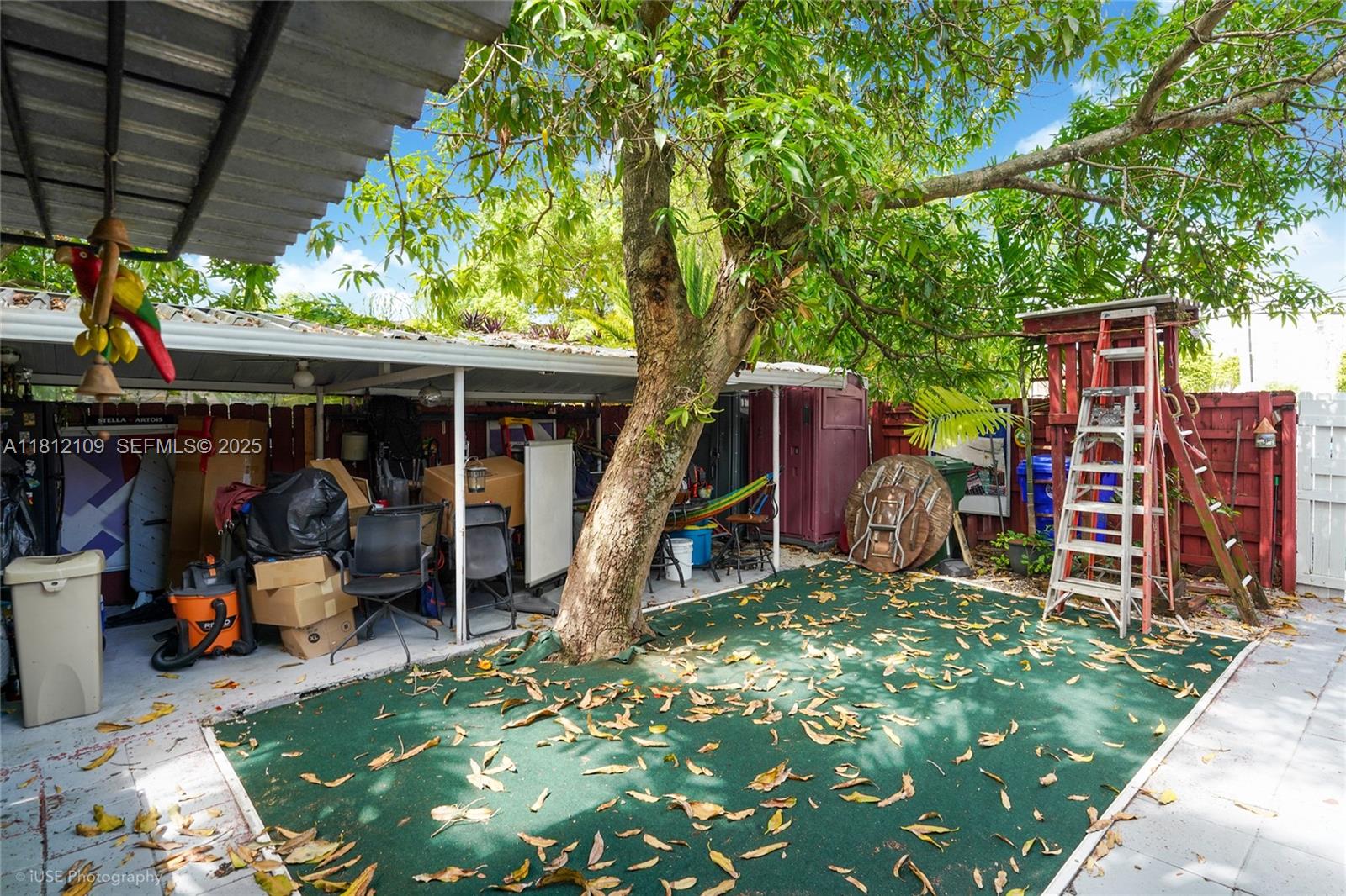 901 Southwest 34th Avenue Miami, FL 33135 - Photo 18 of 18 a view of a garage with a table and chairs under an umbrella