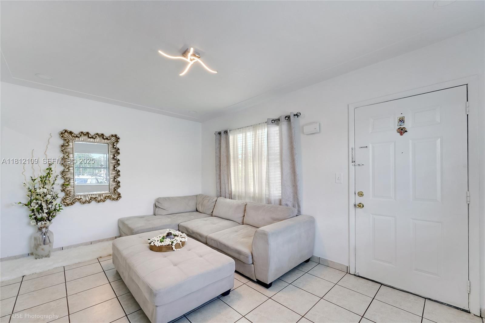 901 Southwest 34th Avenue Miami, FL 33135 - Photo 5 of 18 a living room with furniture and a window