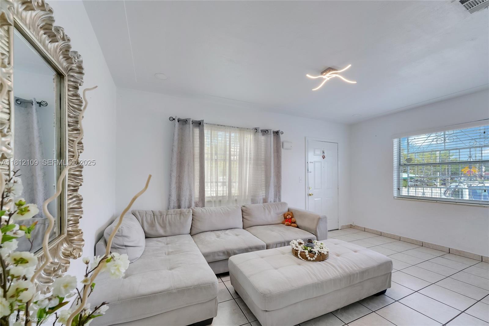 901 Southwest 34th Avenue Miami, FL 33135 - Photo 6 of 18 a living room with furniture and a window