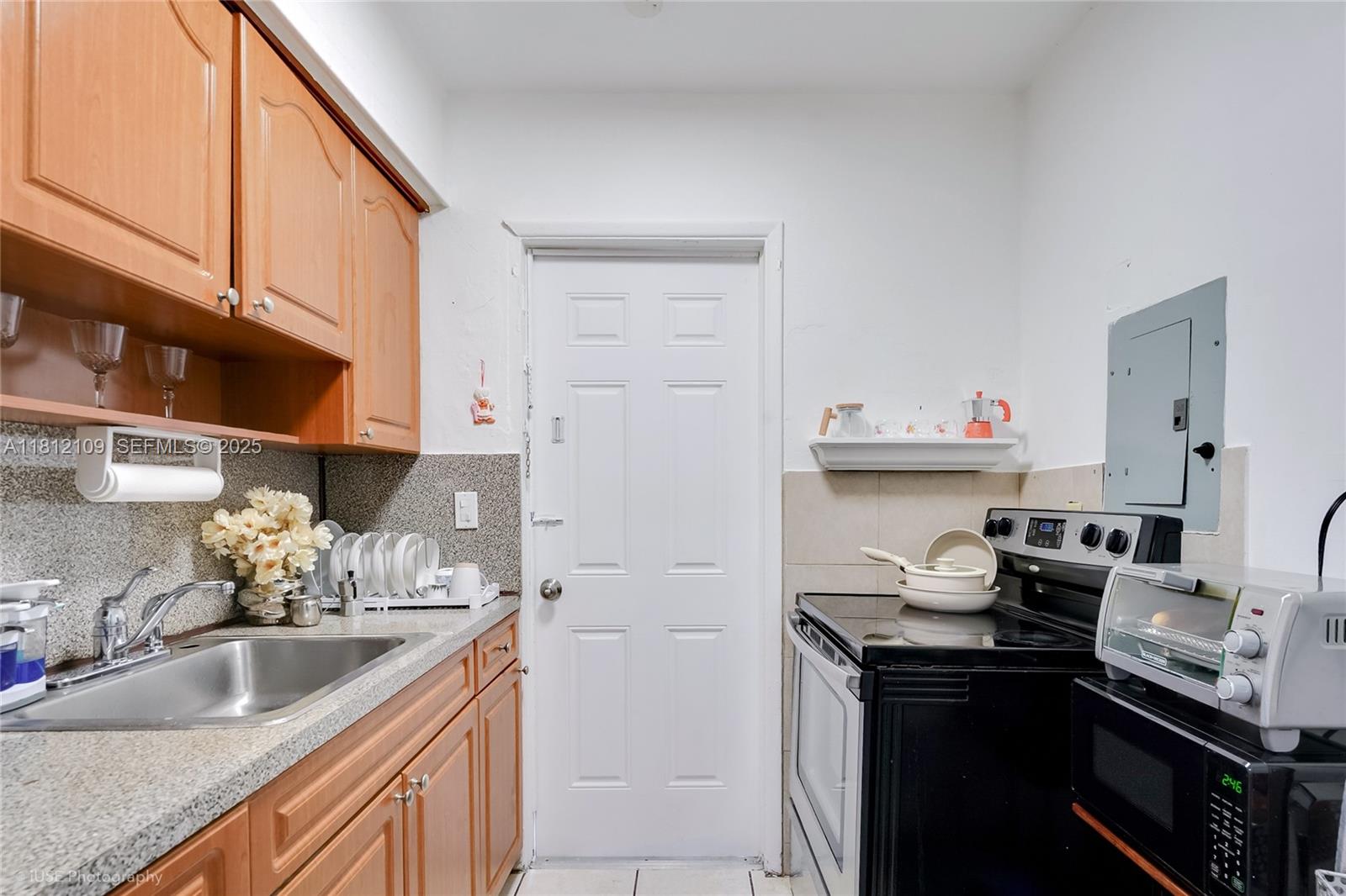 901 Southwest 34th Avenue Miami, FL 33135 - Photo 10 of 18 a kitchen with stainless steel appliances granite countertop a sink stove and cabinets