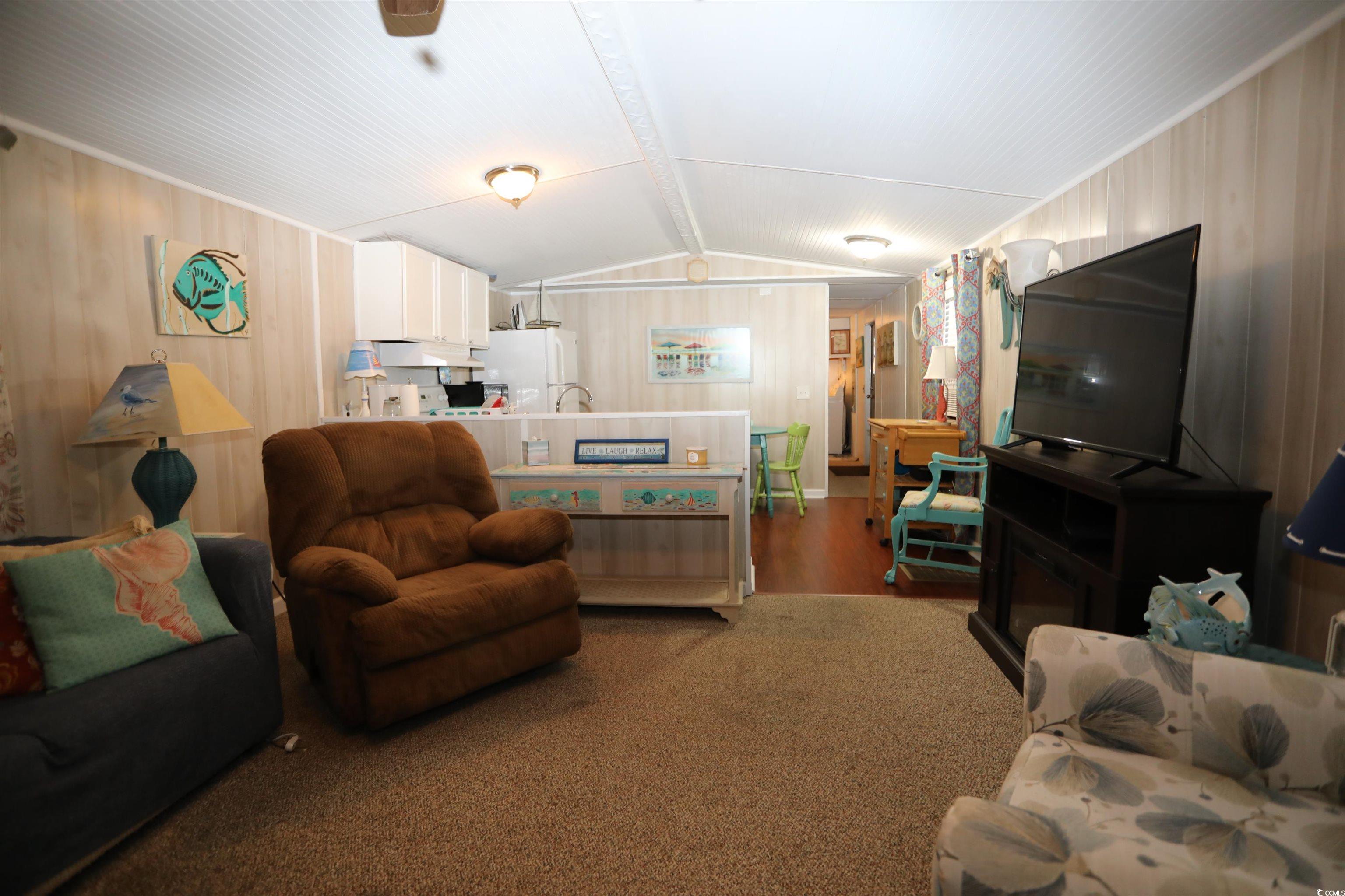 724 1st Street Murrells Inlet, SC 29576 - Photo 14 of 18 Laundry area with wood walls, washing machine and clothes dryer, and light flooring