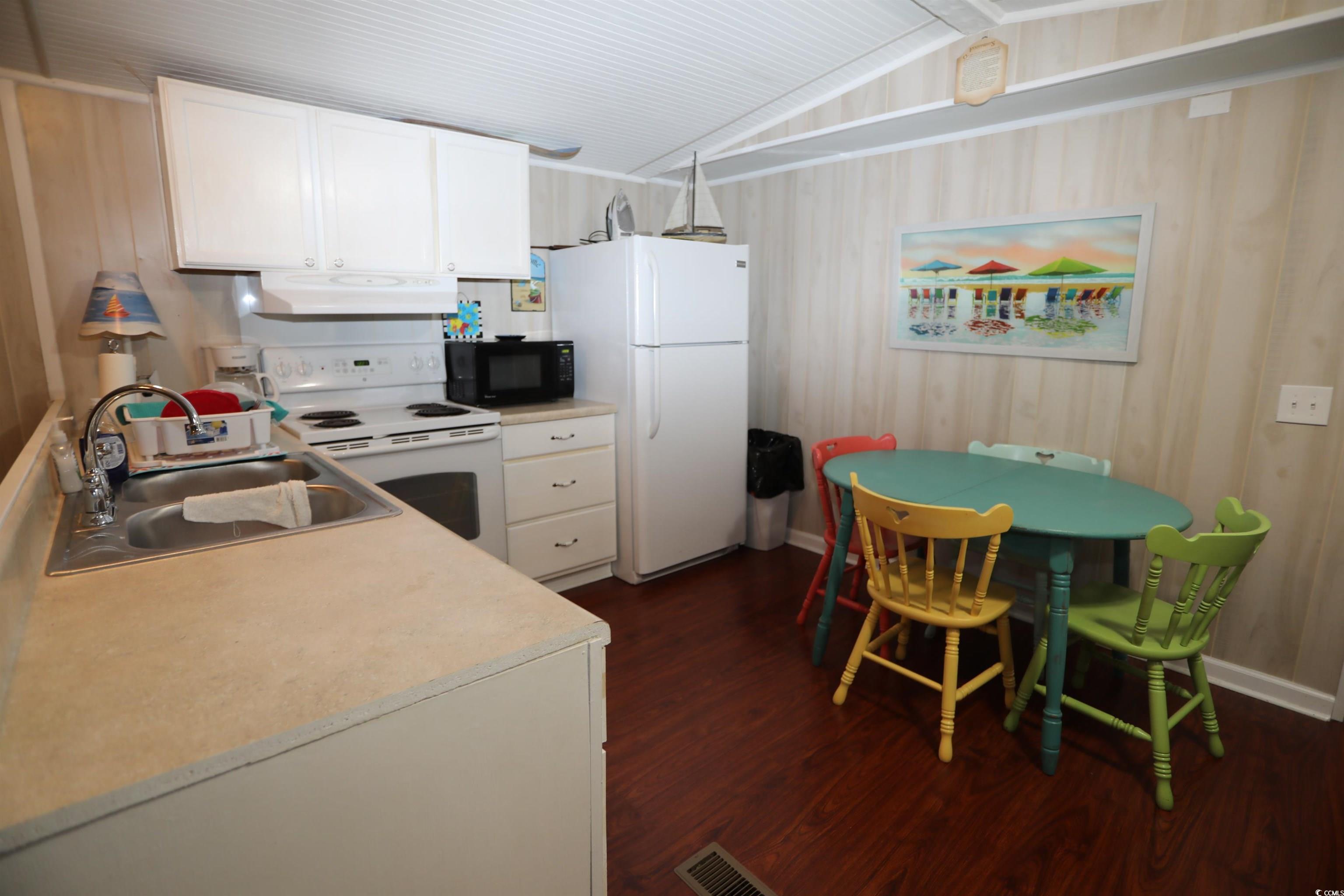 724 1st Street Murrells Inlet, SC 29576 - Photo 15 of 18 Carpeted bedroom featuring wooden walls and ceiling fan