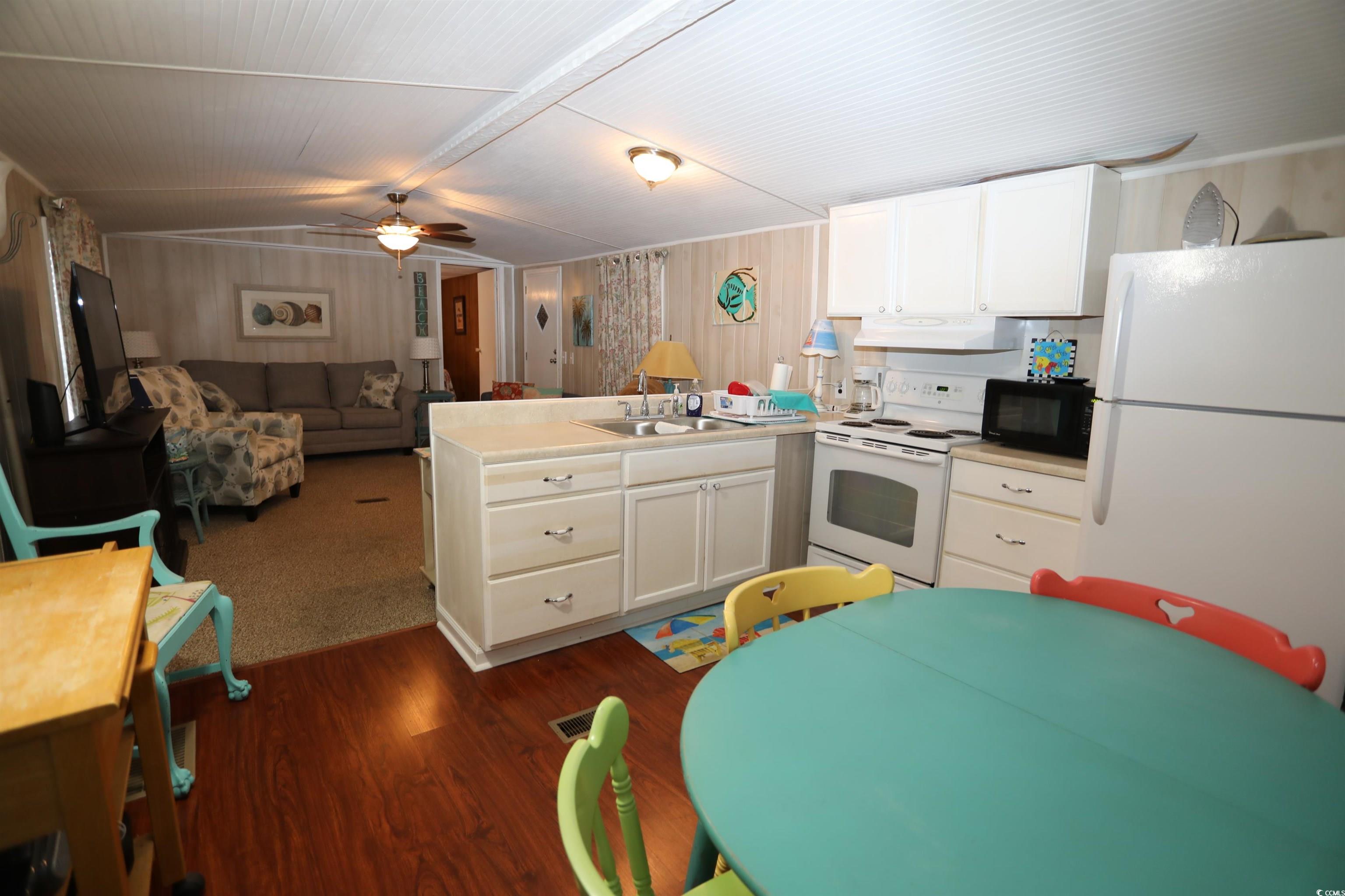 724 1st Street Murrells Inlet, SC 29576 - Photo 16 of 18 Living room featuring lofted ceiling, ceiling fan, and carpet