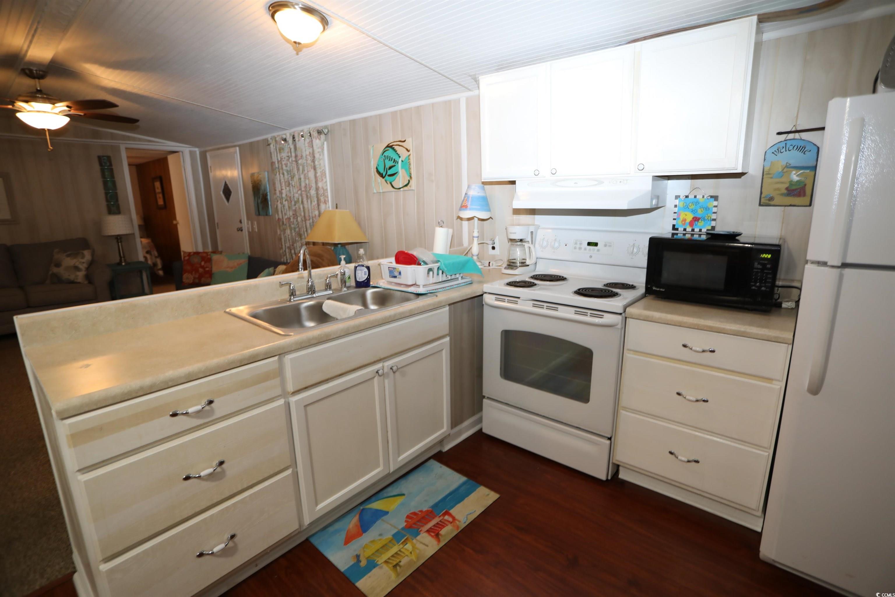 724 1st Street Murrells Inlet, SC 29576 - Photo 18 of 18 Living area featuring wood walls