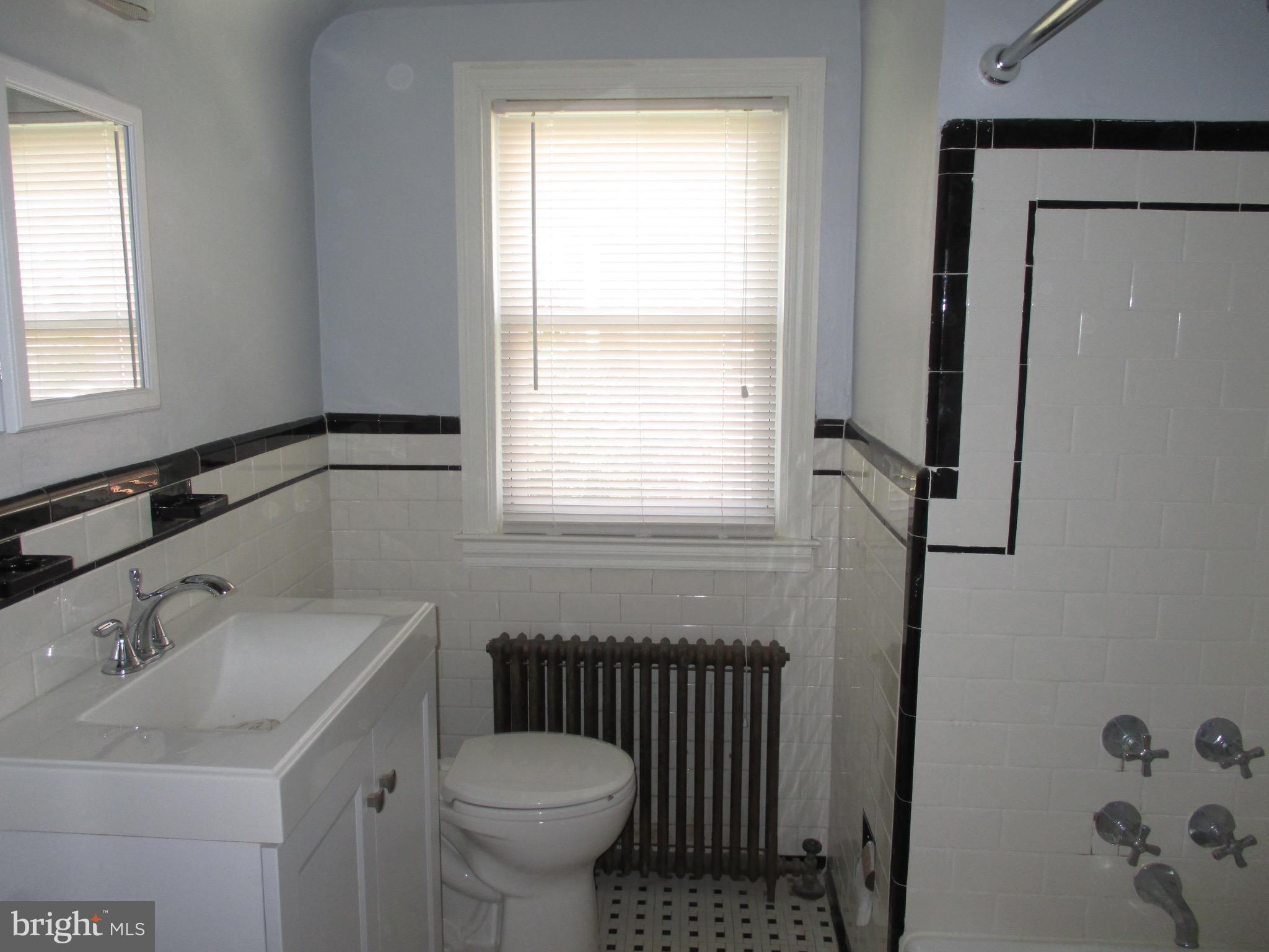 716 Dorchester Road Baltimore, MD 21229 - Photo 11 of 20 a bathroom with a sink and a window