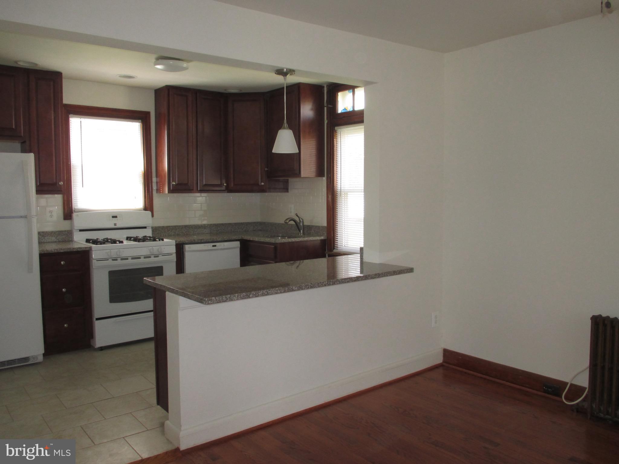 716 Dorchester Road Baltimore, MD 21229 - Photo 7 of 20 a kitchen with a sink cabinets and window