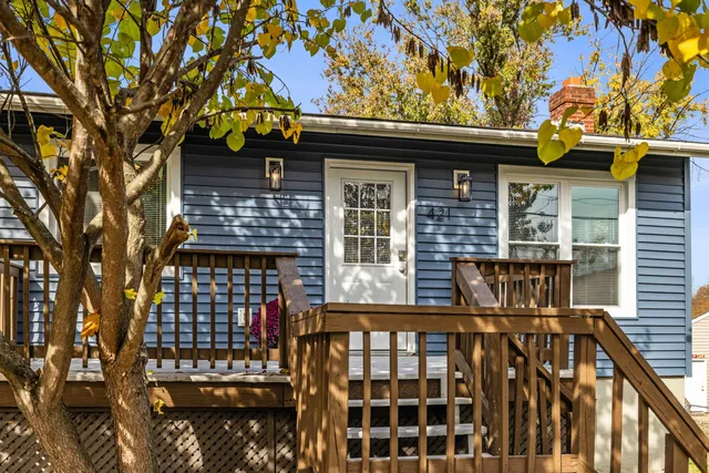 a living room with furniture potted plant and a flat screen tv
