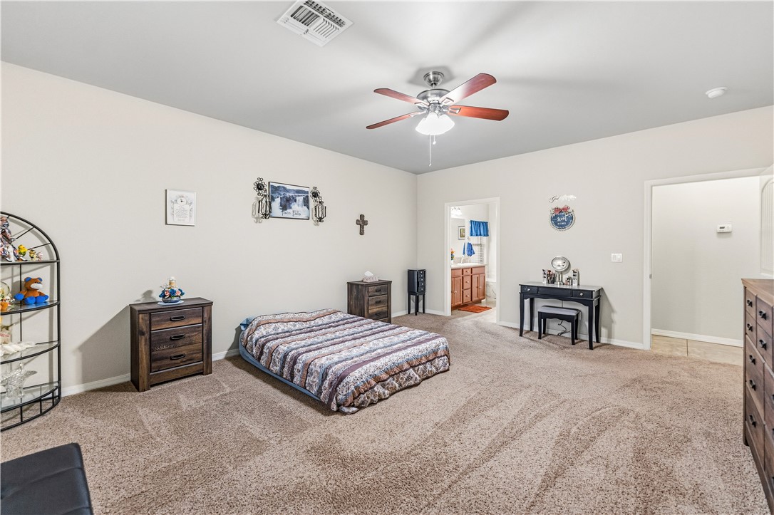 4143 North Stampede Road Kingman, AZ 86401 - Photo 17 of 42 Spacious room featuring neutral carpeting, light-toned walls, and a ceiling fan with integrated lighting