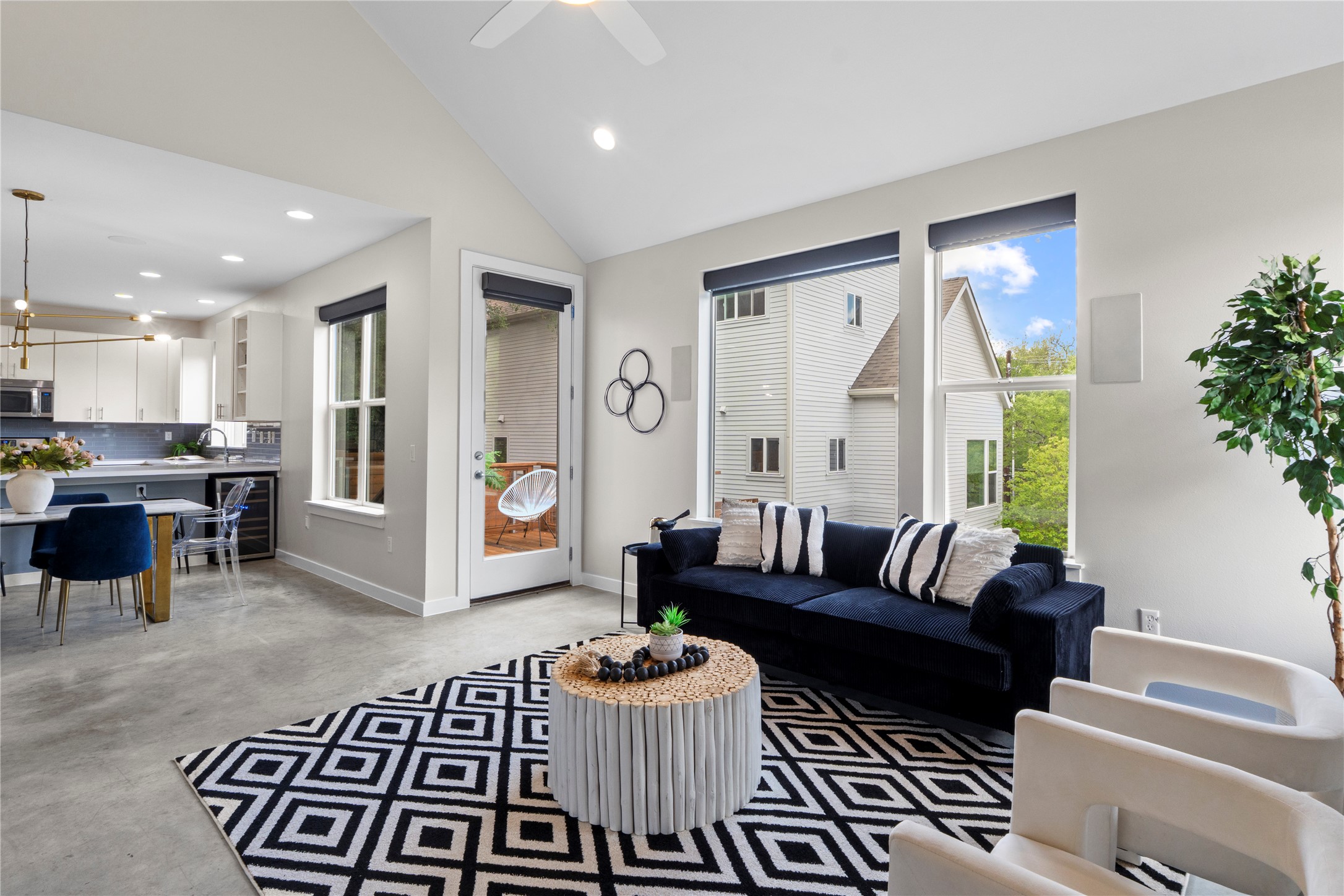 3001 Del Curto Road, Unit 35 Austin, TX 78704 - Photo 5 of 22 The open concept living area features high vaulted ceilings, large windows providing natural light, and concrete flooring