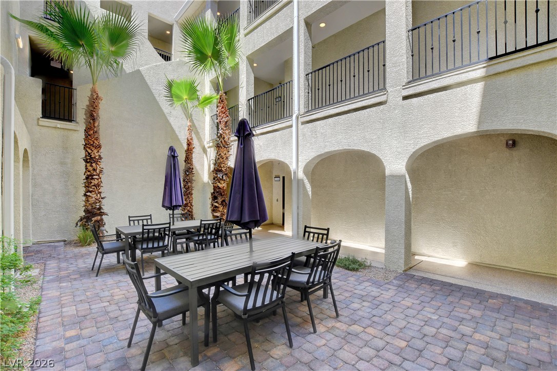2555 Hampton Road, Unit 2207 Henderson, NV 89052 - Photo 4 of 74 An inviting courtyard features paver flooring, mature palm trees, and ample seating for social gatherings.