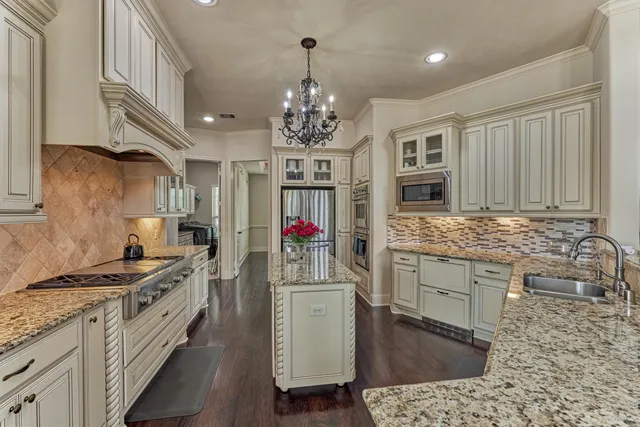 a kitchen with a sink stove and wooden cabinets