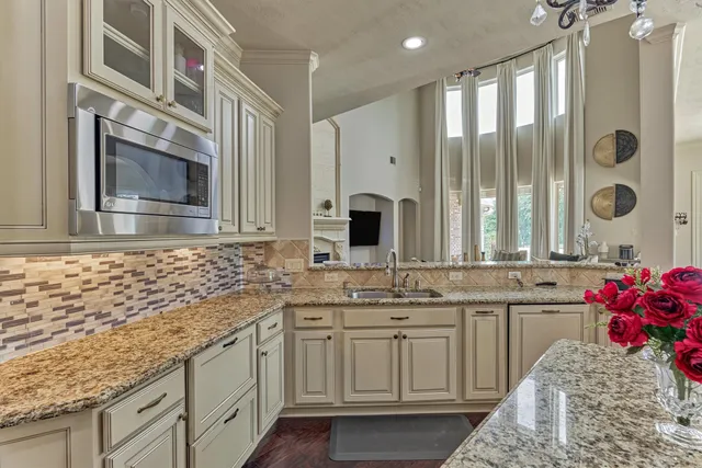 a kitchen with stainless steel appliances granite countertop a sink and cabinets