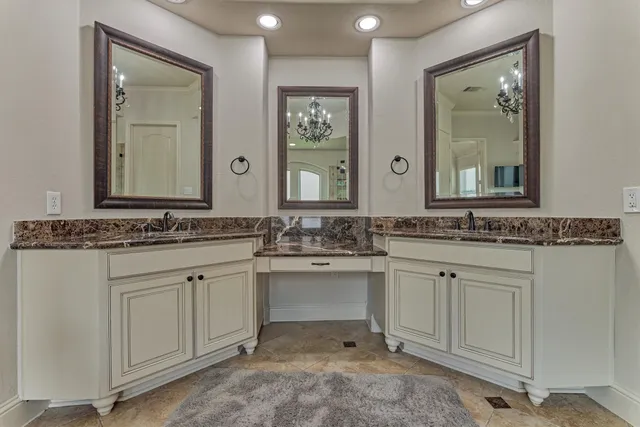 a spacious bathroom with a granite countertop tub sink and mirror