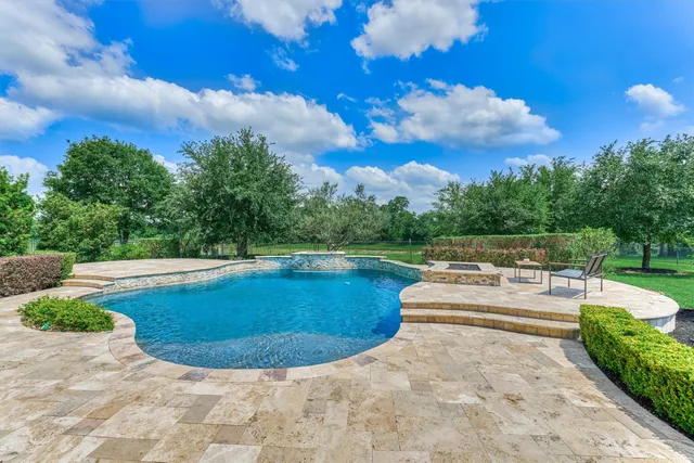 a view of a swimming pool with a yard