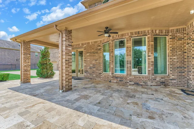a bathroom with a granite countertop toilet sink and mirror