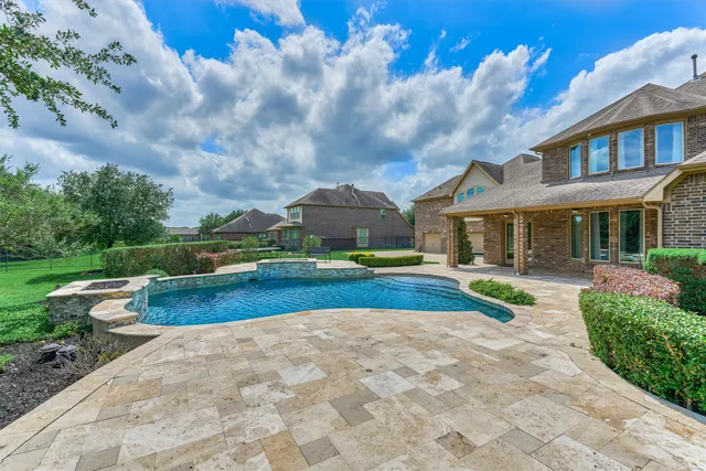 a view of a backyard with swimming pool