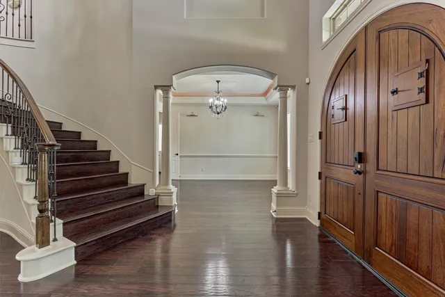 a view of entryway and hall with wooden floor