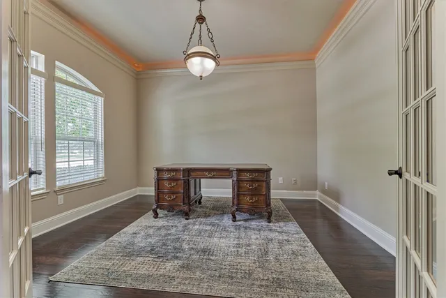 a view of a livingroom with wooden floor and a window