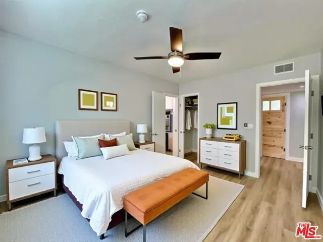 a bedroom with a bed and wooden floor