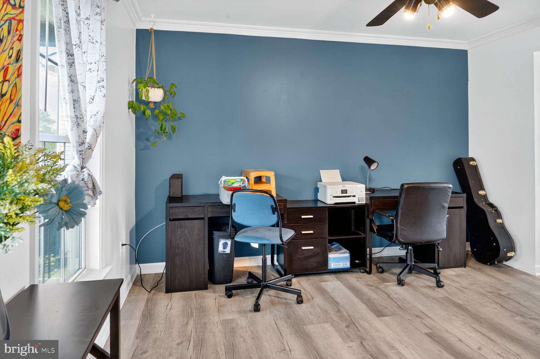 71 Fairground Avenue Taneytown, MD 21787 - Photo 11 of 36 a view of a workspace with furniture and a potted plant