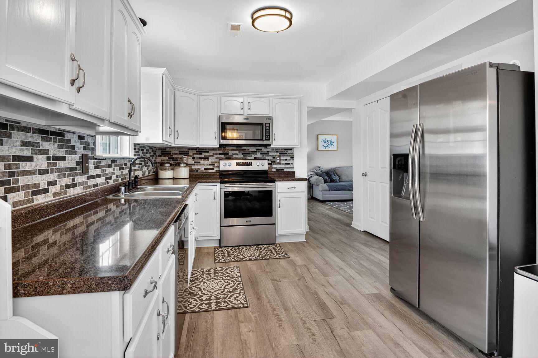 71 Fairground Avenue Taneytown, MD 21787 - Photo 5 of 36 a kitchen with stainless steel appliances granite countertop a refrigerator a stove and a sink