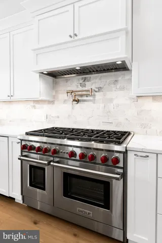 a stove top oven sitting inside of a kitchen
