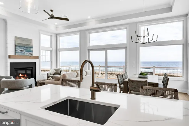 a living room with furniture a large window and a fireplace