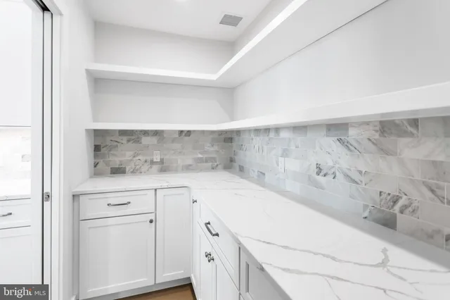 a bathroom with a sink mirror vanity and toilet