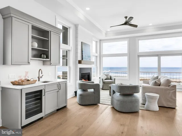 a living room with furniture a large window and a flat screen tv