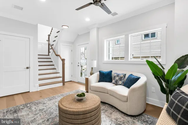 a view of a big room with wooden floor and windows