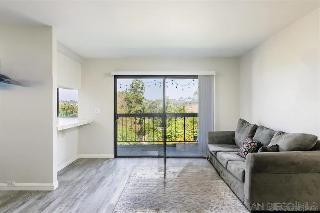 5125 Fontaine Street, Unit 205 San Diego, CA 92120 - Photo 1 of 18 a living room with furniture and a window