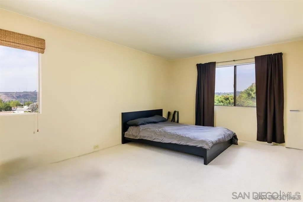 5125 Fontaine Street, Unit 205 San Diego, CA 92120 - Photo 7 of 18 a bedroom with a bed and window