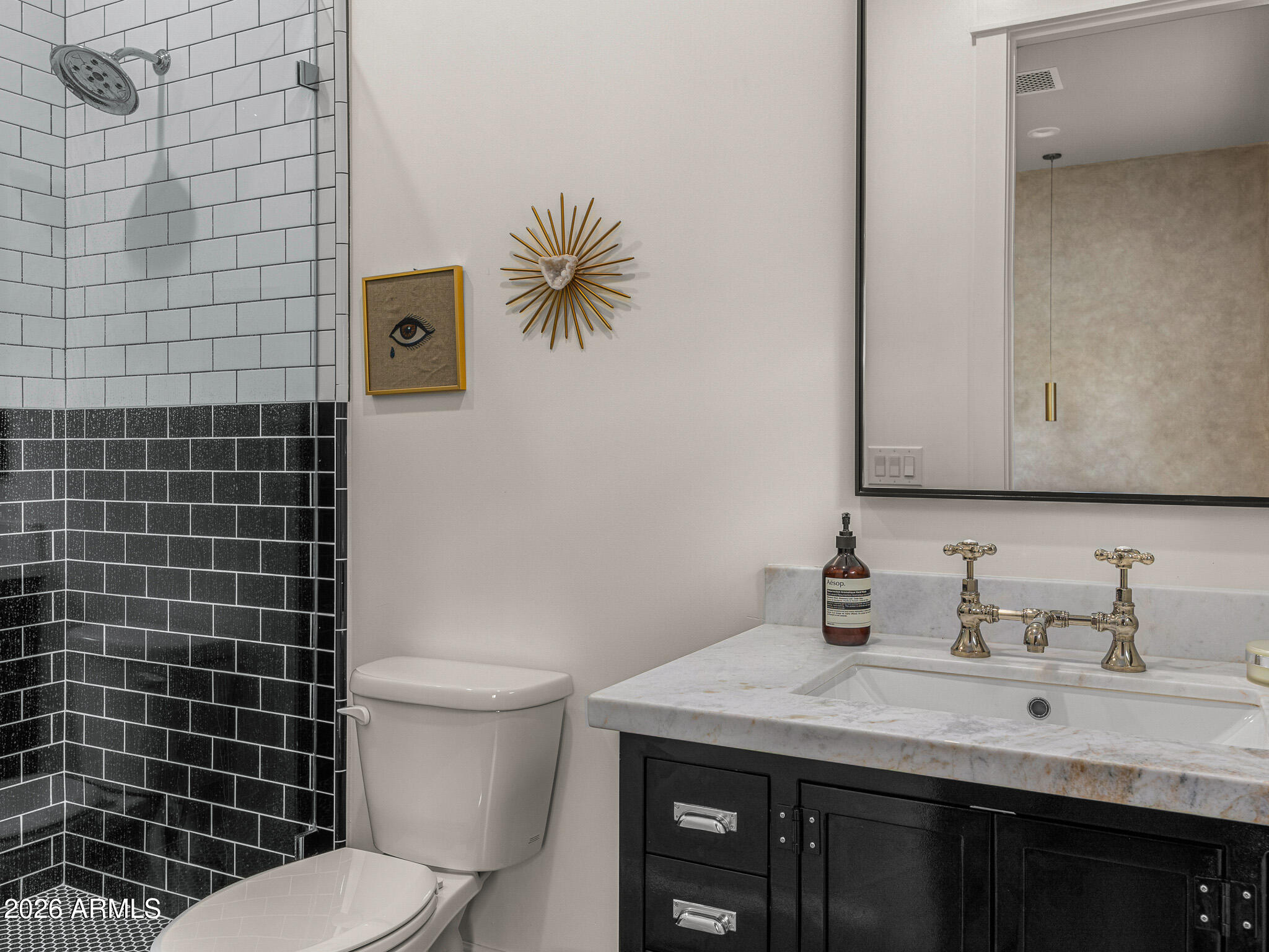 4204 North 57th Way Phoenix, AZ 85018 - Photo 23 of 34 a bathroom with a granite countertop toilet sink and mirror