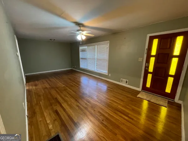 wooden floor in an empty room with a window