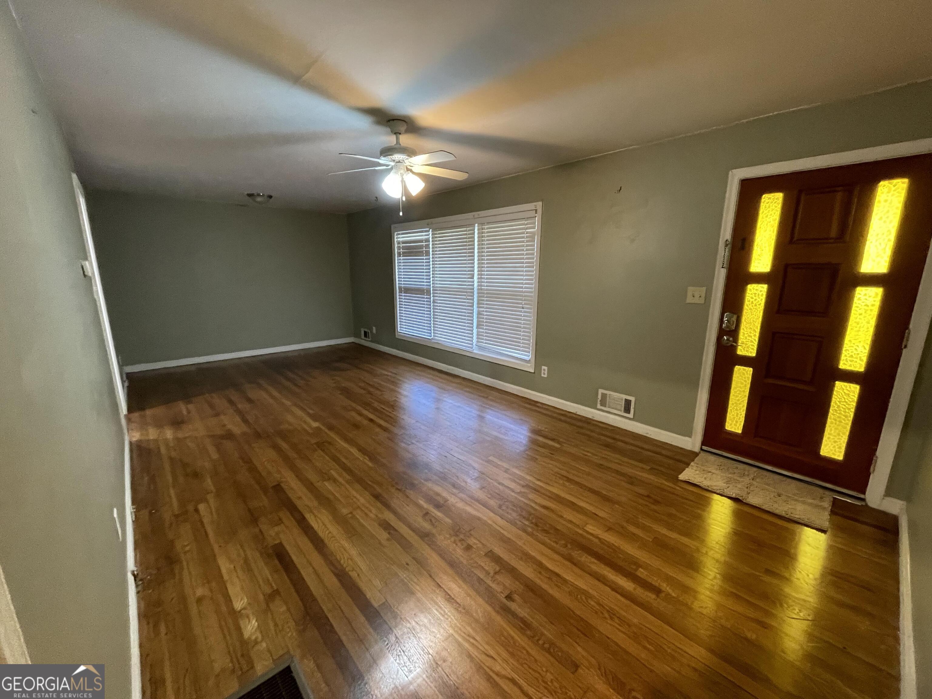 1211 Robinwood Road Decatur, GA 30033 - Photo 2 of 8 wooden floor in an empty room with a window