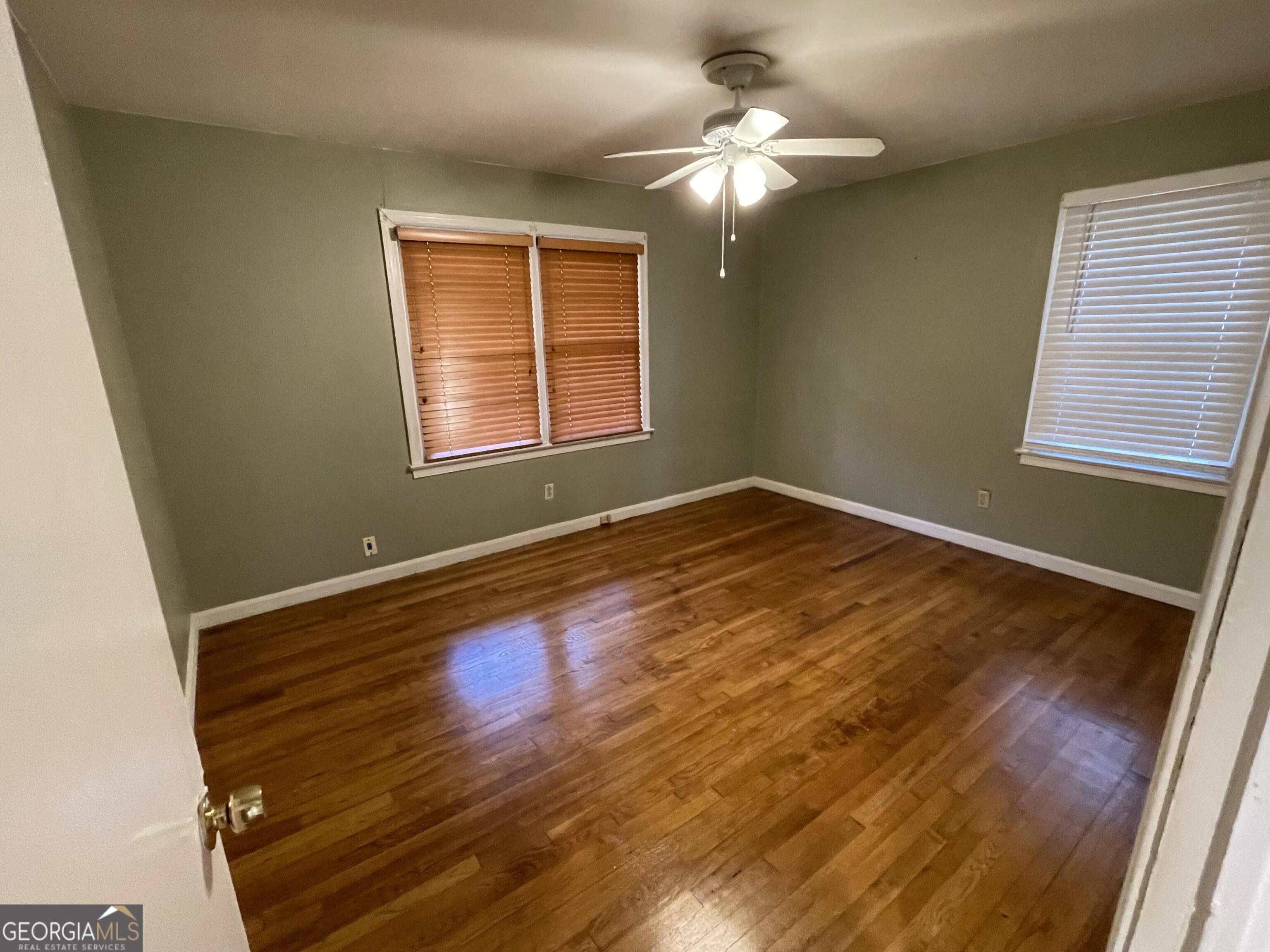 1211 Robinwood Road Decatur, GA 30033 - Photo 3 of 8 a view of an empty room with wooden floor and a window