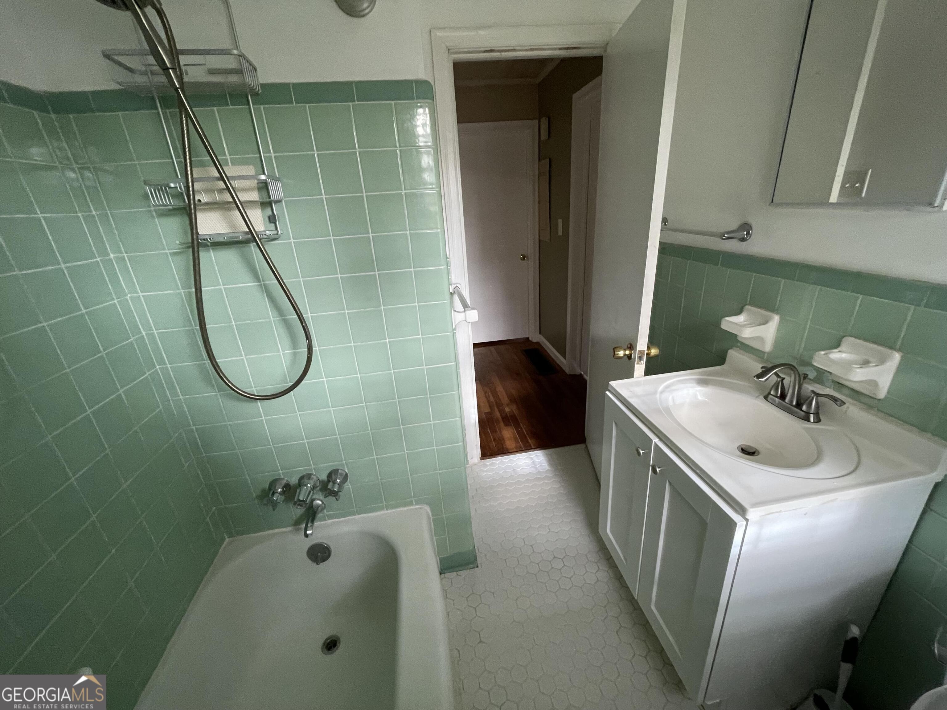 1211 Robinwood Road Decatur, GA 30033 - Photo 7 of 8 a bathroom with a sink a toilet and shower