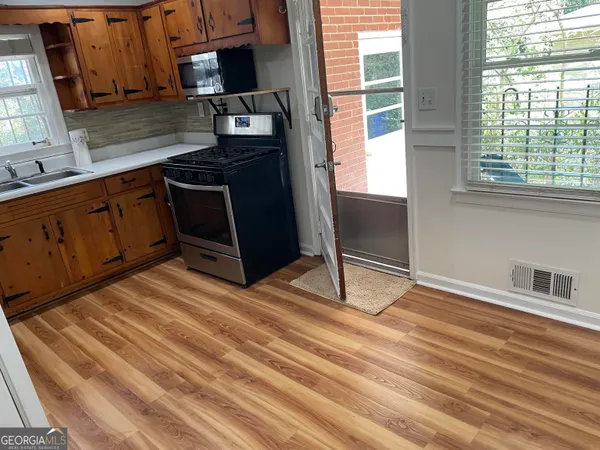 a kitchen with a sink cabinets and a wooden floor