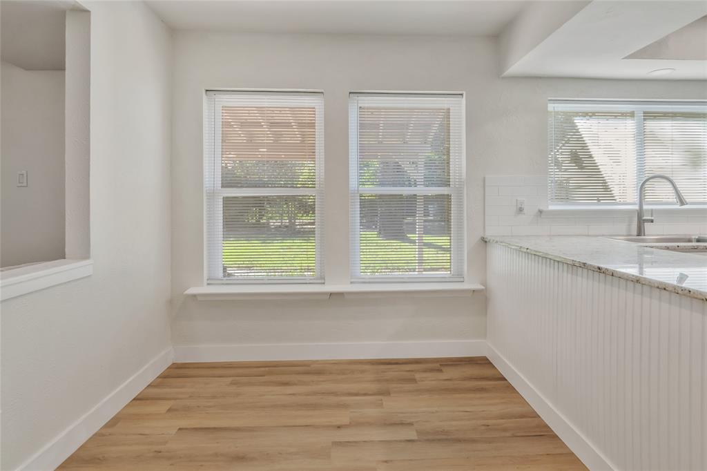 3708 Spring Meadow Lane Flower Mound, TX 75028 - Photo 12 of 39 a view of a kitchen with wooden floor and a window